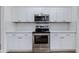 Updated kitchen features stainless steel appliances and modern white cabinets at 15046 W Cooperstown Way, Surprise, AZ 85374