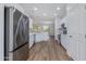 Modern kitchen with stainless steel appliances, white cabinets, and an open floor plan at 15046 W Cooperstown Way, Surprise, AZ 85374