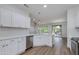 Bright kitchen featuring white cabinets, stainless appliances, and an open floor plan at 15046 W Cooperstown Way, Surprise, AZ 85374
