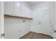 Well-lit laundry room with white cabinets and a durable hard-surface floor at 15046 W Cooperstown Way, Surprise, AZ 85374