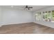 Spacious living room features wood-look flooring, ceiling fan, and ample natural light at 15046 W Cooperstown Way, Surprise, AZ 85374
