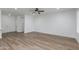 Bright living room features wood floors, ceiling fan and neutral paint at 15046 W Cooperstown Way, Surprise, AZ 85374