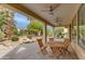 Covered patio perfect for entertaining, featuring a wooden table and backyard views at 15046 W Cooperstown Way, Surprise, AZ 85374