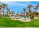 Resort-style pool area with plenty of lounge chairs for relaxing and a building nearby at 15046 W Cooperstown Way, Surprise, AZ 85374