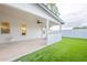 Backyard patio features artificial grass, a ceiling fan, and access door to inside at 15255 N 5Th Ln, Phoenix, AZ 85023