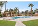 Inviting community pool featuring a covered patio and well-maintained landscaping, providing a relaxing atmosphere at 15255 N 5Th Ln, Phoenix, AZ 85023