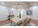 Well-lit dining room features wood floors, modern lighting, stylish decor and painted brick accent wall at 15255 N 5Th Ln, Phoenix, AZ 85023