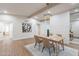 Bright dining area with wood floors, modern light fixture, and decorative painting at 15255 N 5Th Ln, Phoenix, AZ 85023