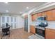 Modern kitchen area with stainless steel appliances, wood cabinets and adjacent dining area at 15255 N 5Th Ln, Phoenix, AZ 85023