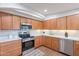 Well-lit kitchen with stainless steel appliances, wood cabinets, and white countertops at 15255 N 5Th Ln, Phoenix, AZ 85023
