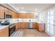 Well-equipped kitchen features stainless steel appliances, ample counter space, and wood cabinets at 15255 N 5Th Ln, Phoenix, AZ 85023
