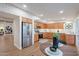 Modern kitchen with stainless steel appliances, wood cabinets, and adjacent dining area at 15255 N 5Th Ln, Phoenix, AZ 85023