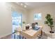 Home office featuring a desk, chair, rug, and sliding glass door to the covered patio at 15255 N 5Th Ln, Phoenix, AZ 85023