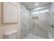 The remodeled bathroom features stylish tiled shower and gold fixtures at 15255 N 5Th Ln, Phoenix, AZ 85023