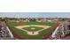 Aerial view of a lively baseball field, surrounded by fans, with well-manicured green grass at 16428 N 39Th Pl, Phoenix, AZ 85032