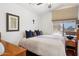 Bright bedroom with soft lighting, window, neutral walls, and a comfortable bed with decorative pillows at 16428 N 39Th Pl, Phoenix, AZ 85032
