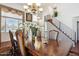 Dining room with hardwood floors, a chandelier, staircase and a view to the upper level of the home at 16428 N 39Th Pl, Phoenix, AZ 85032