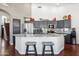 Kitchen with granite countertops, grey cabinetry, stainless steel appliances, and breakfast bar at 16428 N 39Th Pl, Phoenix, AZ 85032