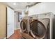 Spacious laundry room featuring modern front-load washer and dryer and lots of storage cabinets at 16428 N 39Th Pl, Phoenix, AZ 85032