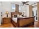 Luxurious main bedroom with a large bed, hardwood floors, and decorative window treatments at 16428 N 39Th Pl, Phoenix, AZ 85032