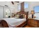 A large bedroom with hardwood floors, a decorative headboard, an ensuite bathroom and lots of natural light at 16428 N 39Th Pl, Phoenix, AZ 85032