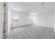 Carpeted bedroom with bright white walls and two sunny windows offering desert views at 17264 W Via Dona Rd, Surprise, AZ 85387