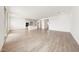 Spacious living area with wood-look tile flooring, ample natural light, and open access to the kitchen at 17264 W Via Dona Rd, Surprise, AZ 85387