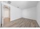 Bedroom featuring wood look floors and a spacious layout, offering a modern and minimalist aesthetic at 17295 W Via Dona Rd, Surprise, AZ 85387