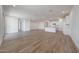 Open-concept living space featuring a bright interior, wood-style tile flooring, and access to the kitchen at 17295 W Via Dona Rd, Surprise, AZ 85387