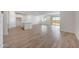 Spacious living area boasts wood-style tile flooring, an open floor plan, and access to the backyard at 17295 W Via Dona Rd, Surprise, AZ 85387