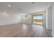 Bright living room features tile flooring, contemporary design, and sliding door access to the backyard at 17295 W Via Dona Rd, Surprise, AZ 85387