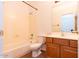 Standard bathroom featuring a bathtub, toilet, sink with cabinet, and neutral wall color at 17633 W Wind Song Ave, Goodyear, AZ 85338
