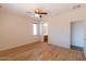 Bright bedroom with light wood floors, bathroom access, and a neutral color palette at 17633 W Wind Song Ave, Goodyear, AZ 85338