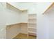 Walk-in closet with built-in shelving and clothing racks for ample storage space at 17633 W Wind Song Ave, Goodyear, AZ 85338
