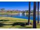 Lake with water feature and lush landscape and palm trees providing a scenic view at 17633 W Wind Song Ave, Goodyear, AZ 85338