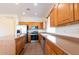 Modern kitchen with stainless steel appliances, ample countertops, and tile floors at 17633 W Wind Song Ave, Goodyear, AZ 85338