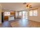 Open-concept living area with stainless appliances, breakfast bar, and lots of natural light at 17633 W Wind Song Ave, Goodyear, AZ 85338