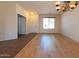 Light-filled living room with new floors, neutral walls, and a view to the entry at 17633 W Wind Song Ave, Goodyear, AZ 85338