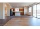 Open-concept layout with tile flooring connecting the kitchen and living areas with abundant natural light at 17633 W Wind Song Ave, Goodyear, AZ 85338