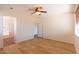Spacious main bedroom with ceiling fan, laminate floors, and an adjoining bathroom at 17633 W Wind Song Ave, Goodyear, AZ 85338