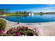 A picturesque water feature is surrounded by vibrant flowers and greenery, enhancing the community's beauty at 17633 W Wind Song Ave, Goodyear, AZ 85338