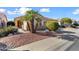 Beautifully landscaped front yard featuring decorative rock, mature trees, and walkway to front door at 17643 W Weatherby Dr, Surprise, AZ 85374