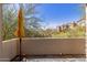 Balcony patio with desert landscaping, tile floors, and umbrella stand at 19550 N Grayhawk Dr # 1044, Scottsdale, AZ 85255