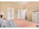 This bedroom is equipped with a walk-in closet, an ensuite bathroom and wood flooring at 19550 N Grayhawk Dr # 1044, Scottsdale, AZ 85255