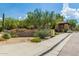 Entrance to the Cachet at Grayhawk gated community with landscaping, trees, and well-maintained sidewalks at 19550 N Grayhawk Dr # 1044, Scottsdale, AZ 85255