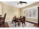 This dining room features hardwood floors, modern table, a ceiling fan, and shuttered windows at 19550 N Grayhawk Dr # 1044, Scottsdale, AZ 85255