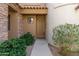 Close-up view of a neutral colored door framed by desert landscaping at 19550 N Grayhawk Dr # 1044, Scottsdale, AZ 85255