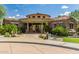 Community center exterior featuring a stone facade, tile roof, and manicured landscaping at 19550 N Grayhawk Dr # 1044, Scottsdale, AZ 85255