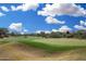 Picturesque community golf course with green grass, trees, and blue skies at 19550 N Grayhawk Dr # 1044, Scottsdale, AZ 85255