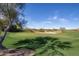 Well-manicured golf course with trees and sand traps and blue skies at 19550 N Grayhawk Dr # 1044, Scottsdale, AZ 85255